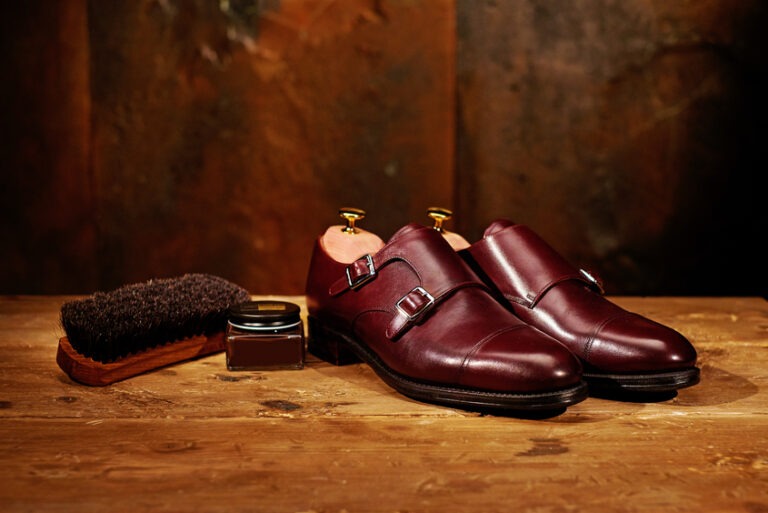 Still life with men's leather shoes and accessories for shoes care