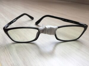 Pair of broken eyeglasses symbolising life failures