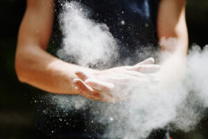 Female climber chalking hands