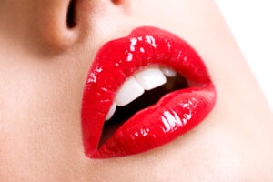 Closeup of female lips with shiny red lipstick