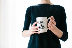 Woman holding mug with Like a Boss written on it